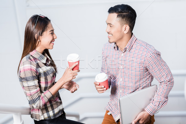 Young man and woman talking while drinking coffee during break Stock photo © Kzenon