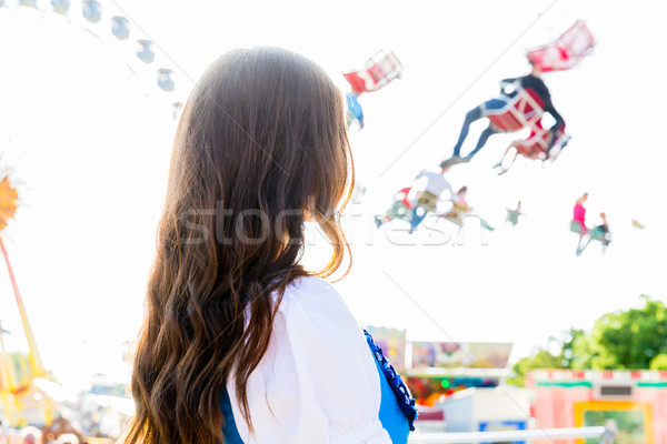 woman wearing dirndl standing in front of ferris wheel Stock photo © Kzenon