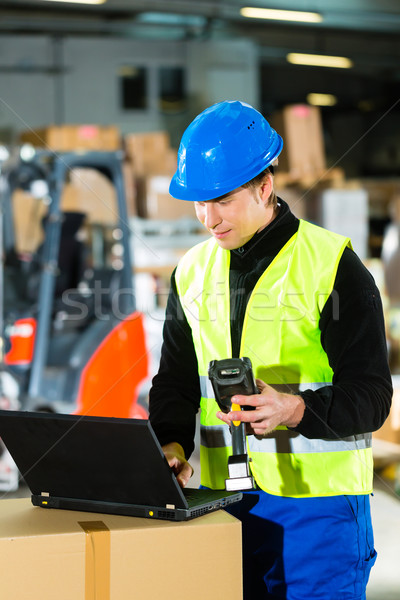 Worker with scanner and laptop at forwarding Stock photo © Kzenon