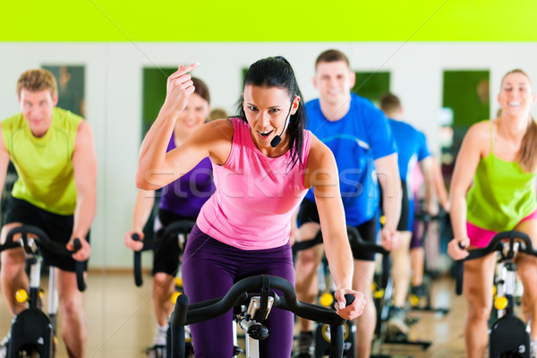 Stock photo: Indoor bycicle cycling in gym