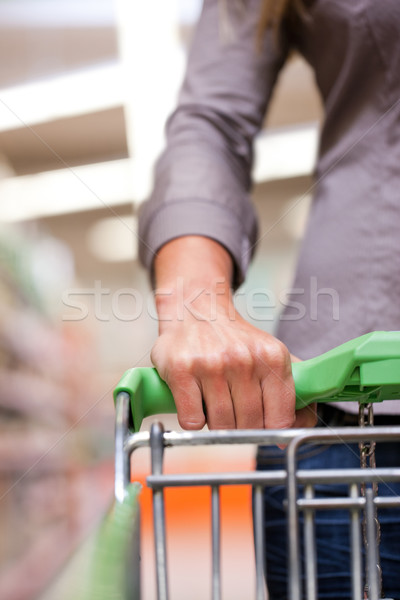 Young woman with pushcart in supermarket Stock photo © Kzenon
