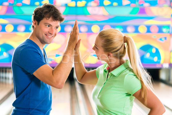 Young people playing bowling and having fun Stock photo © Kzenon
