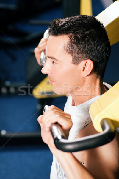 Man exercising and training in gym Stock photo © Kzenon