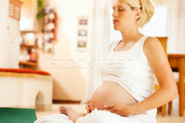 Stock photo: Pregnant woman doing pregnancy yoga