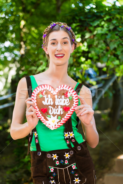 Woman with gingerbread hart in Bavaria beergarden Stock photo © Kzenon