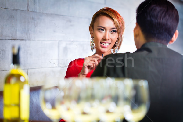 Asian couple drinking white wine in fancy bar Stock photo © Kzenon