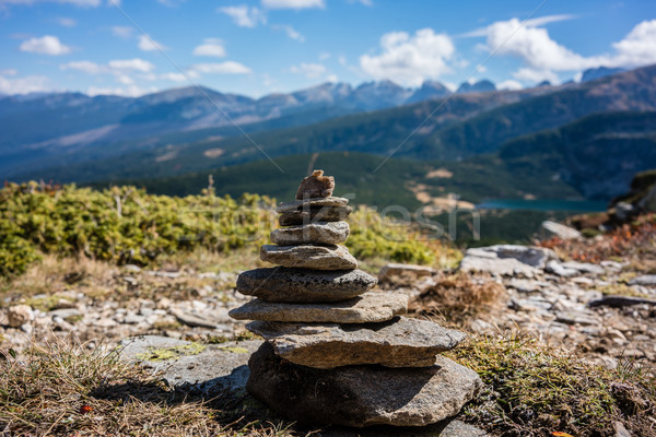 Stone pyramid marking hiking path in the mountains Stock photo © Kzenon