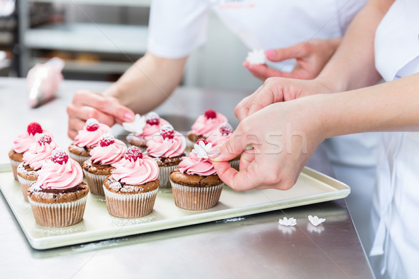 Women in pastry bakery working on muffins Stock photo © Kzenon