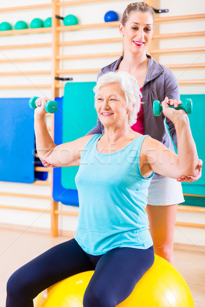 Senior woman with trainer at fitness sport Stock photo © Kzenon