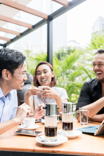 Vietnamese coffee served on the table of three friends outdoors  Stock photo © Kzenon