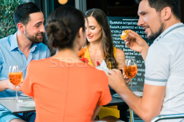 Cheerful friends toasting with a refreshing summer drink Stock photo © Kzenon