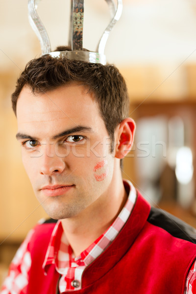 Young man in traditional Bavarian Tracht in restaurant or pub Stock photo © Kzenon