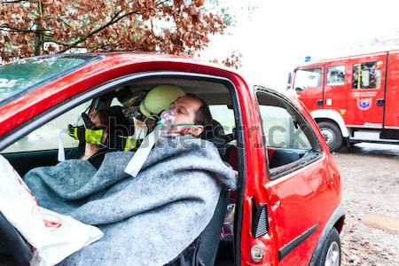 Accident - Fire brigade rescues Victim of a car Stock photo © Kzenon