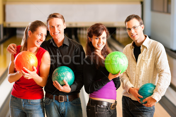 Stock photo: Friends bowling together