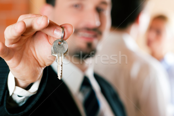 Realtor in apartment giving keys to couple Stock photo © Kzenon