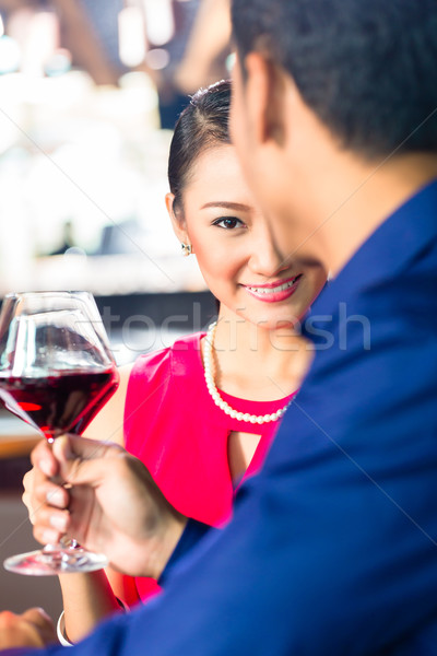 Asian couple with wine in Restaurant Stock photo © Kzenon