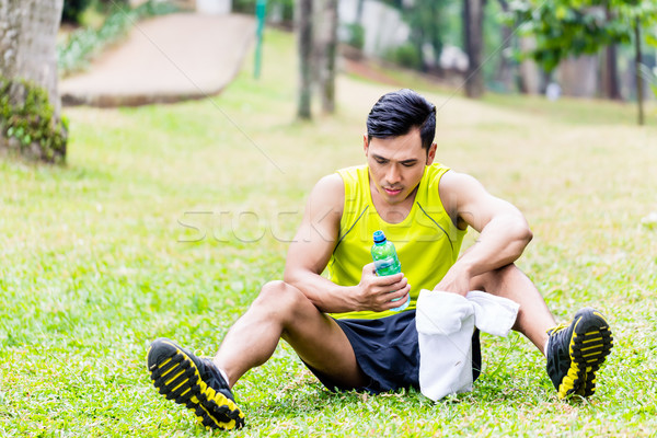 Asian man having break from sport training Stock photo © Kzenon