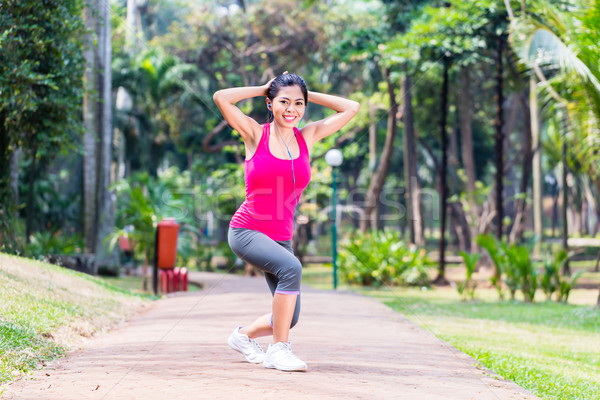 Asian Woman stretching in fitness exercise Stock photo © Kzenon