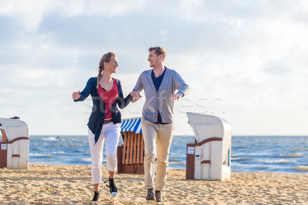 Couple at romantic sunset on beach Stock photo © Kzenon
