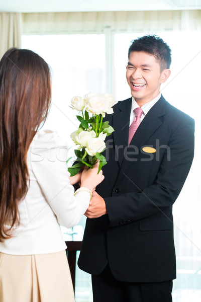 Asian Chinese hotel manager welcoming VIP guest Stock photo © Kzenon