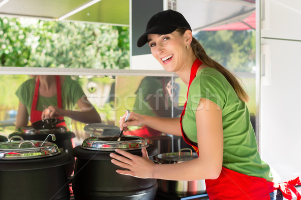 Young emloyee of an concession stand Stock photo © Kzenon