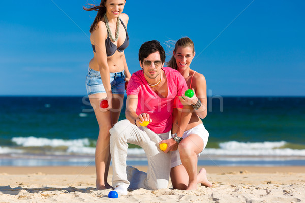 Man and women playing boule on beach Stock photo © Kzenon