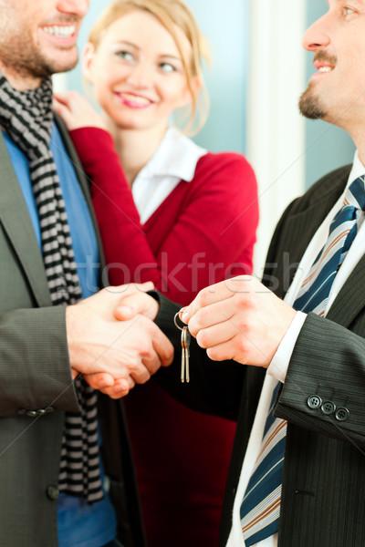 Couple receiving keys from real estate broker Stock photo © Kzenon