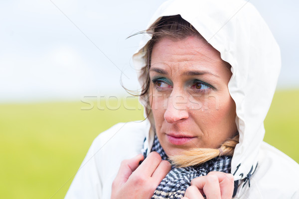 Woman in rain shower at sea coast Stock photo © Kzenon