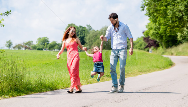 Stock photo: Family letting kid fly in summer walk