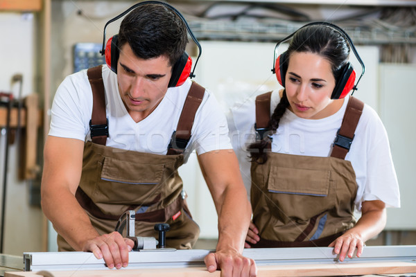 Carpenter and apprentice working together in workshop Stock photo © Kzenon