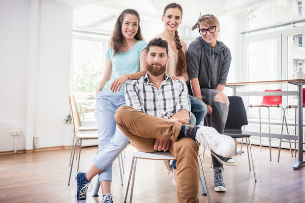 four co-workers wearing casual clothes during work in a modern h Stock photo © Kzenon