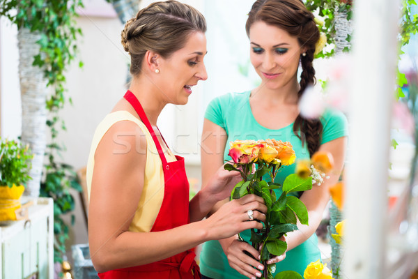 Women in flower store enjoying the roses Stock photo © Kzenon