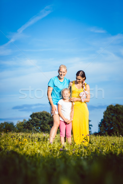 Two women with child on a meadow Stock photo © Kzenon