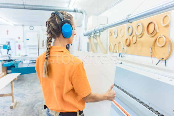 Woman carpenter working in furniture factory Stock photo © Kzenon