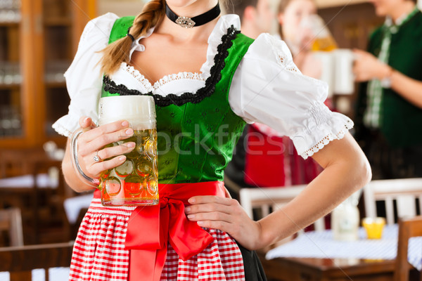 Young people in traditional Bavarian Tracht in restaurant or pub Stock photo © Kzenon