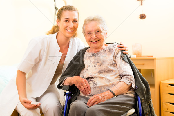 Young nurse and female senior in nursing home Stock photo © Kzenon