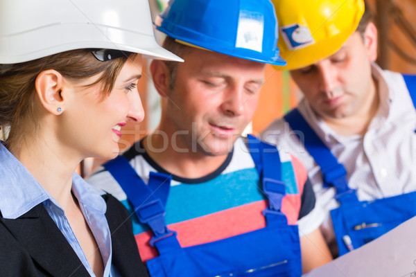 Work Team on construction site controlling floor plan Stock photo © Kzenon