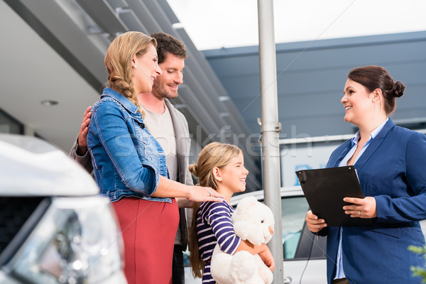 Car dealer advising family on buying auto Stock photo © Kzenon