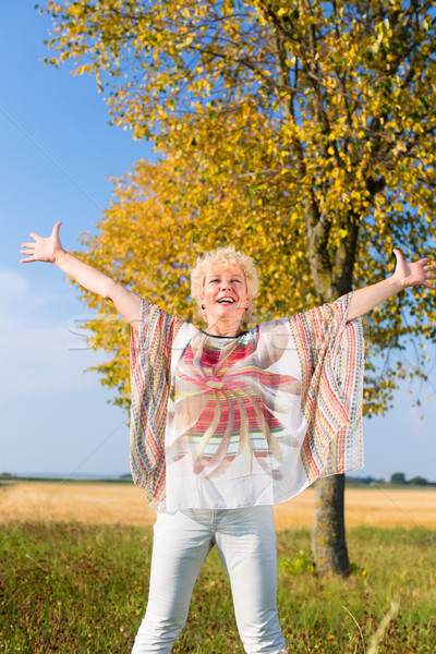 Stock photo: Active senior woman feeling free and happy while standing outdoo