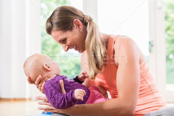 Mom and newborn baby playing together in baby course Stock photo © Kzenon