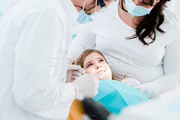 Dentist trearing child in his surgery Stock photo © Kzenon