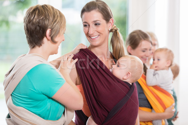 Stock photo: Group of women learning how to use baby slings for mother-child 