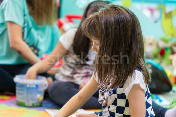 Shy girl looking at her colleagues interacting in the classroom  Stock photo © Kzenon