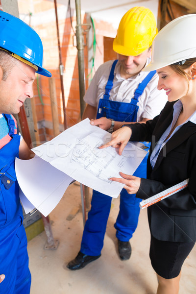 Work Team on construction site controlling floor plan Stock photo © Kzenon