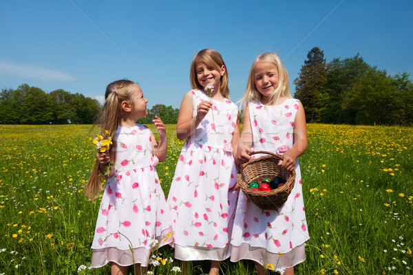 Children on Easter egg hunt with baskets Stock photo © Kzenon