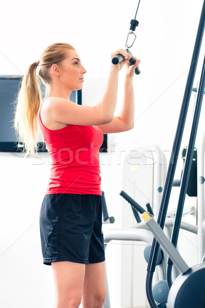 Woman training in gym or sport center Stock photo © Kzenon