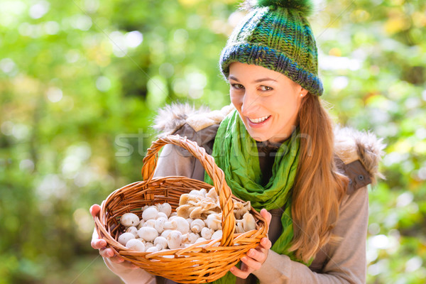 Woman with basket full of champignons in forest Stock photo © Kzenon