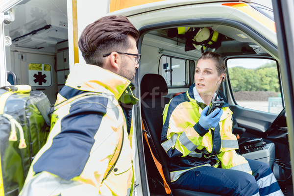 Stock photo: Paramedics in ambulance in radio contact with headquarters