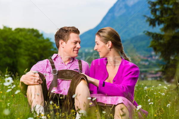 Happy couple in Alpine meadow Stock photo © Kzenon