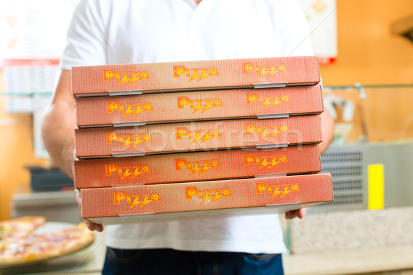 Delivery service - man holding pizza boxes Stock photo © Kzenon